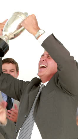 businessman holding cup and cheering with his colleagues