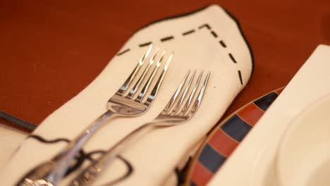 table setting with forks and napkin