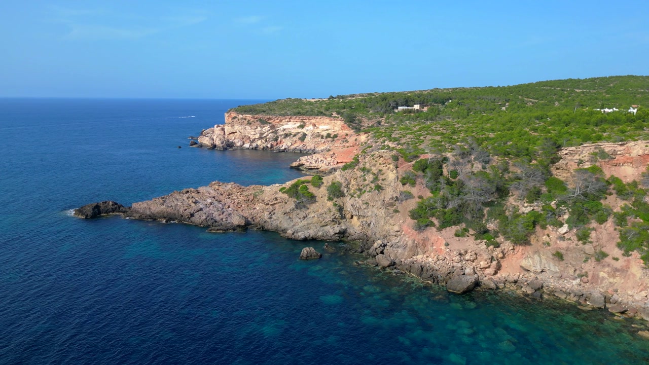 aerial view of the ibiza coastline, showcasing the rugged cliffs and crystal clear turquoise waters of the mediterranean sea. Best aerial view flight panorama orbit drone