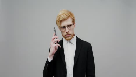 man in a suit talking on the phone