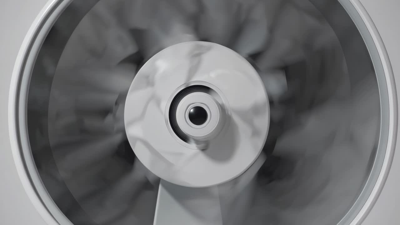 Close-up, top-down view of a spinning fan blade in motion, creating a dynamic and abstract visual