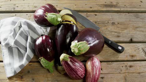 Eggplant-with-knife-on-wooden-table-4k