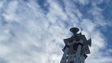 cinematic panning shot of the tower of the minaret mosque with blue skies overhead
