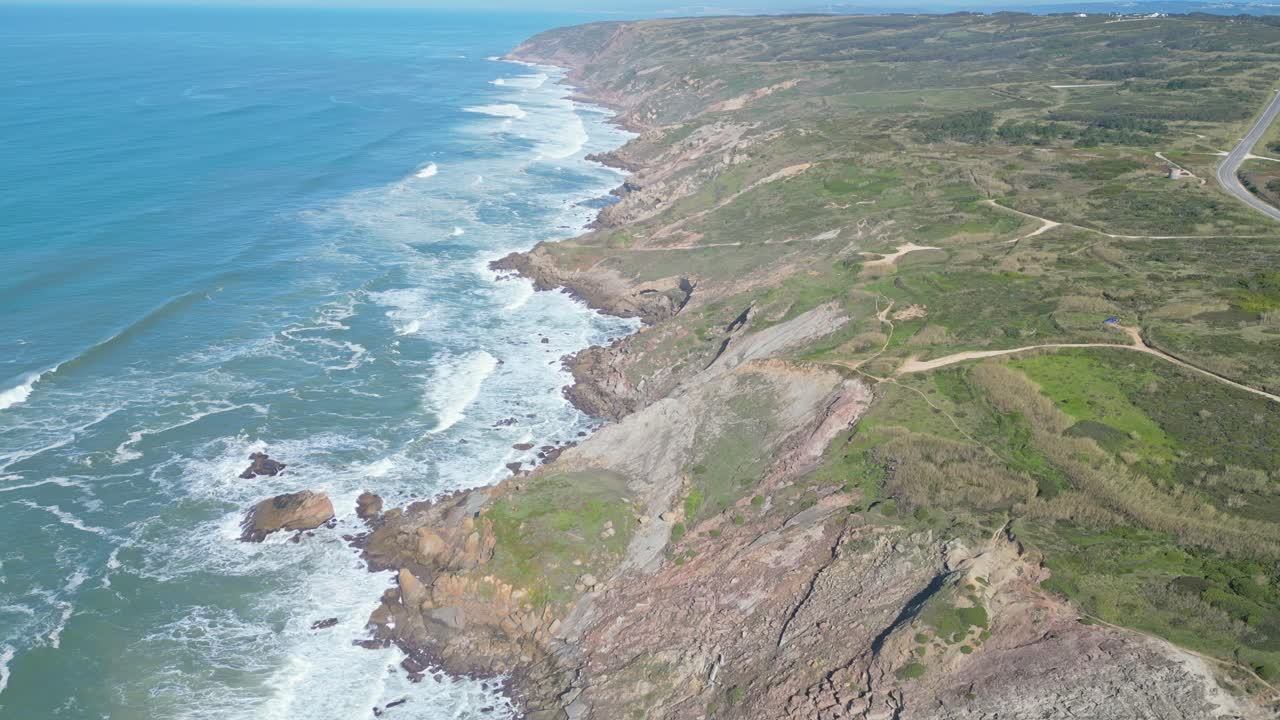 Cliffs and waves at Miradouro do Salgado on a sunny day in Nazaré, Portugal