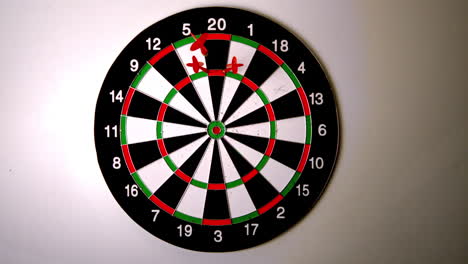 Dart-hitting-the-dart-board-between-two-other-darts