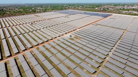 high angle reverse overview of solar field inverters and very dirty panels arrays