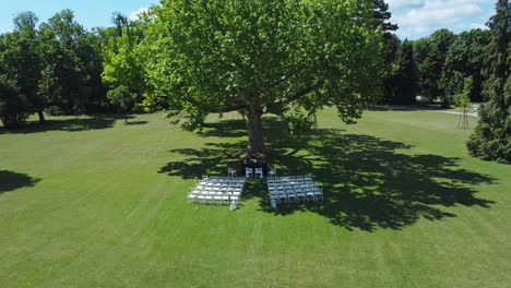 drone shot of an outdoor wedding location in a big and green park