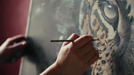 close-up of an artist painting a tiger portrait
