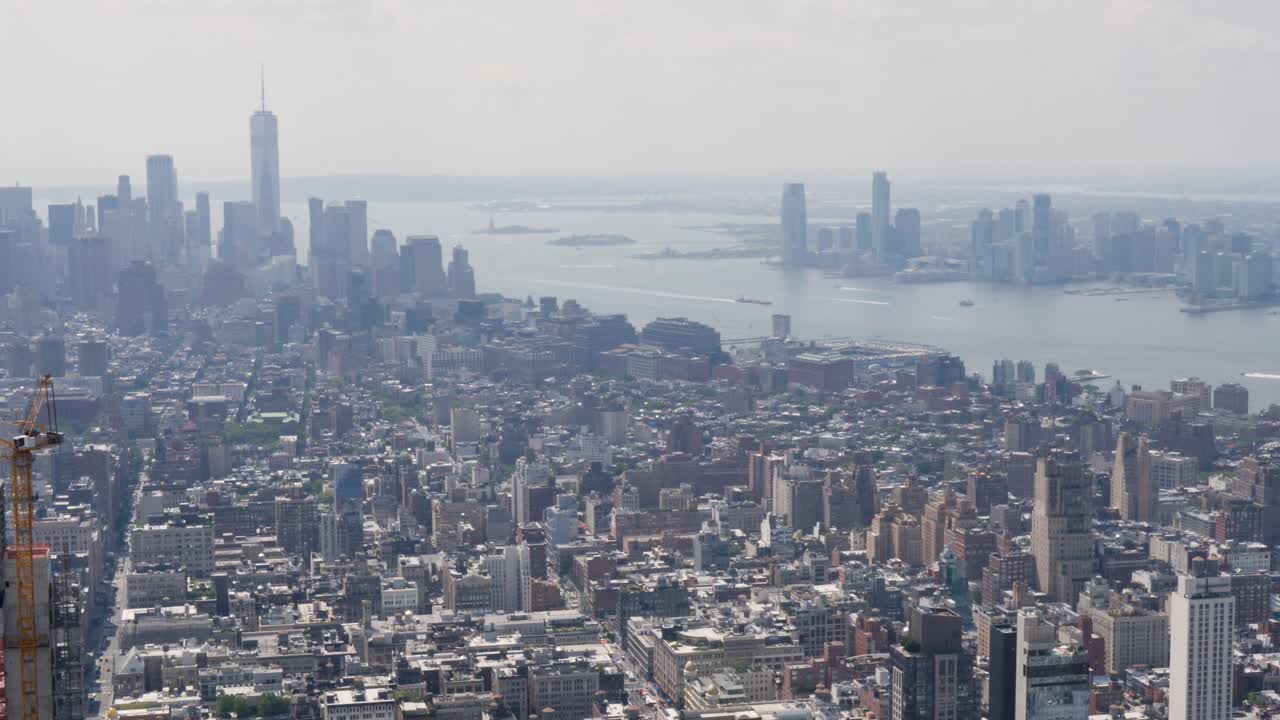 Slow motion landscape of New York city CBD Manhattan Queens from the Empire State Building tower buildings skyscrapers Wall Street Hudson River USA America travel tourism