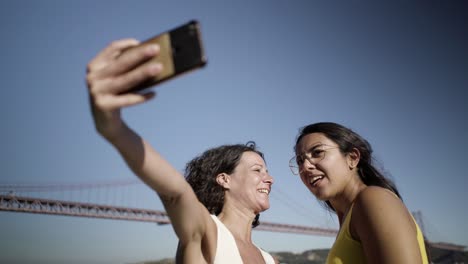 happy friends taking selfie with smartphone