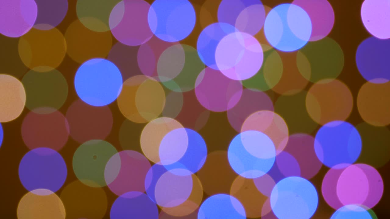 abstract borrón bokeh luces de fiesta brillantes brillo fondo desfocado. fondo de navidad año nuevo uhd 4k. luz desfocada reflejos coloridos bokeh loopable. círculos papel tapiz colorido.