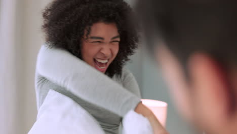 pillow, fight and playful couple laugh