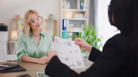 two confident women greet and discuss sales results