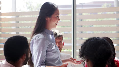 a young asian businesswoman speaks at a meeting in an office