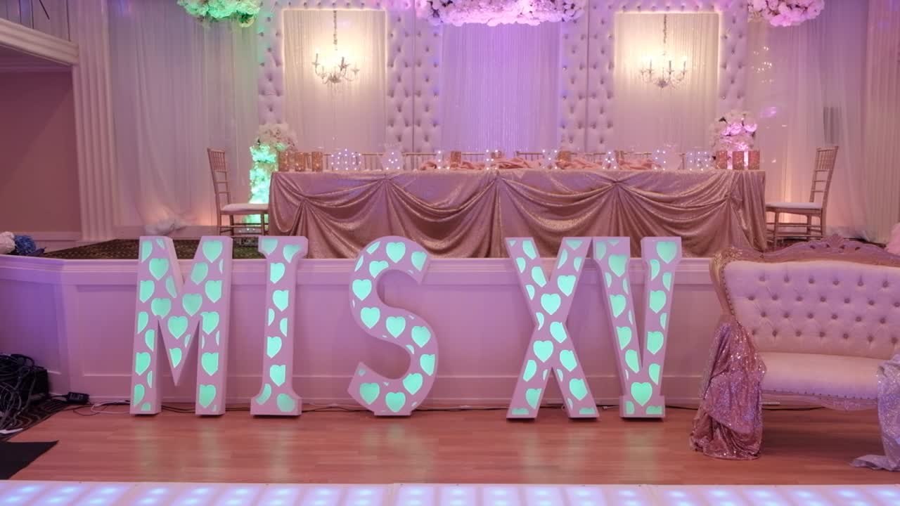 Tilt shot of MIS XV sign next to family table at big 15th birthday party.