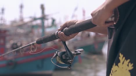 person in traditional dressing catches fish closeup