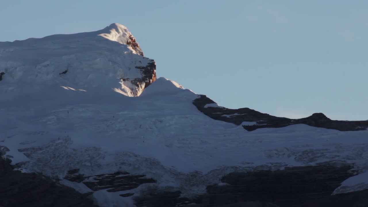 Snowy mountain peak under a blue sky