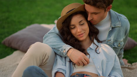 positive man and woman having conversation in park. couple showing tenderness