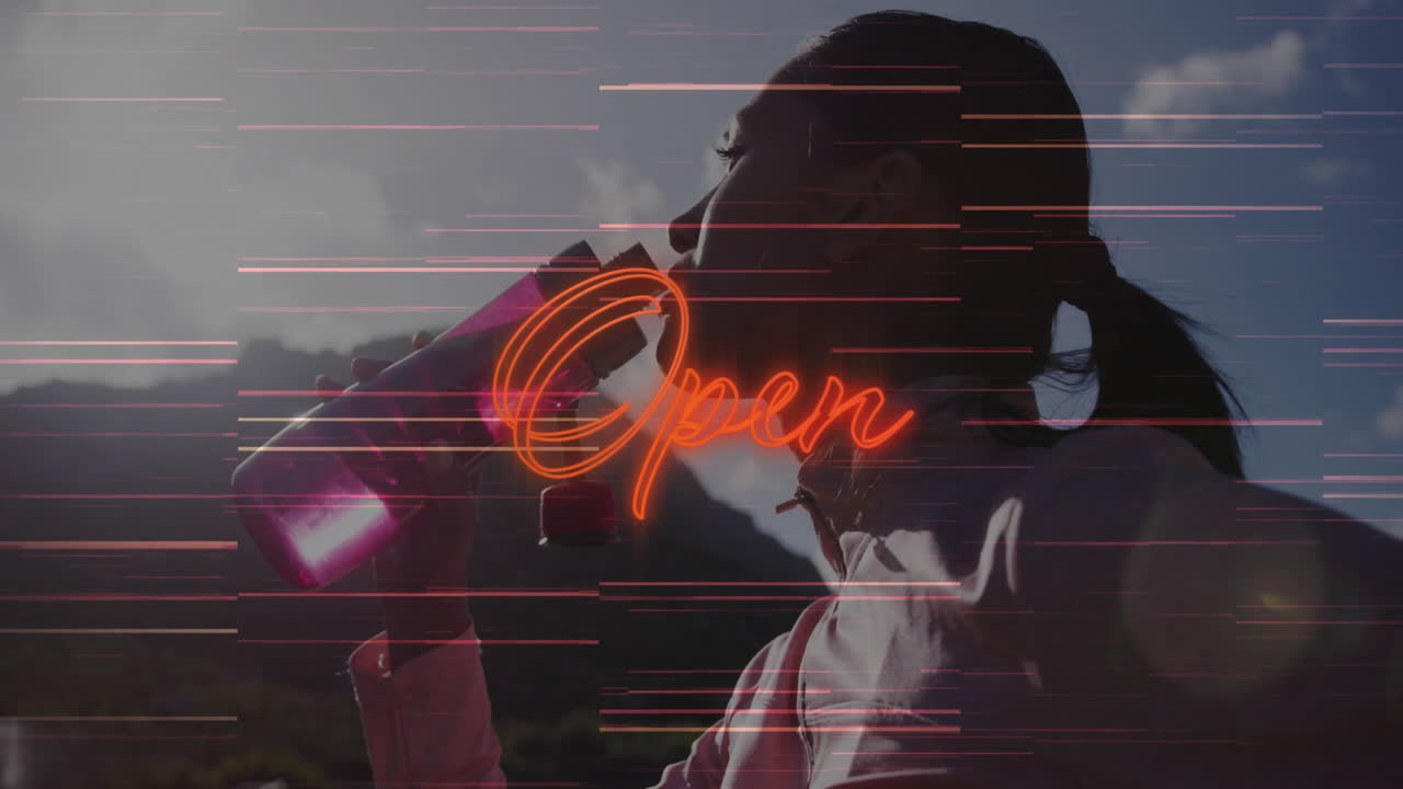 woman drinking from pink bottle on mountain ridge, featuring health tech neon Open text and glitch