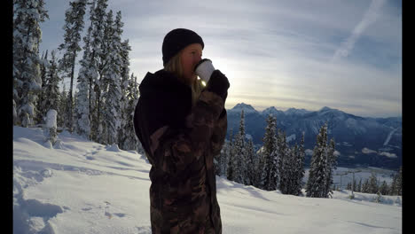 woman with coffee cup standing on the snow covered landscape 4k