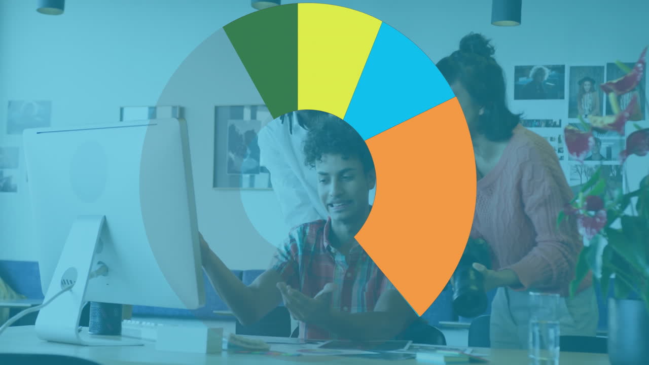 Diverse team collaborating at computer with colorful pie chart animation overlay