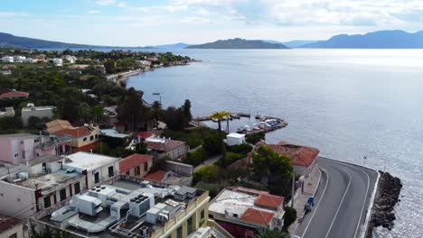 Aerial-drone-bird's-eye-view-photo-of-boats-docked-in-paradise-island-of-Moni-next-to-Aigina-with-emerald-crystal-clear-waters,-Saronic-gulf,-Greece