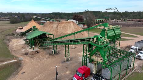 tree grinding and softwood pulp loaded from conveyor into tractor trailer