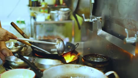 chef skillfully cooks with wok over flame