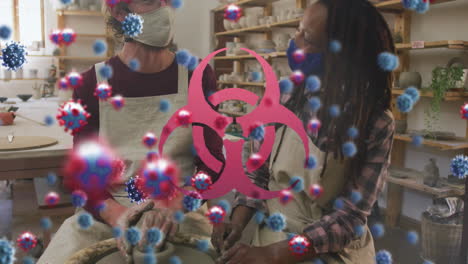 animation of virus cells and biohazard symbol over diverse workers with face masks