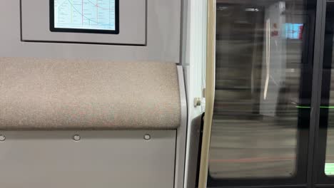 the interior of a modern moscow metro train with an interactive diagram (4k 60, static)