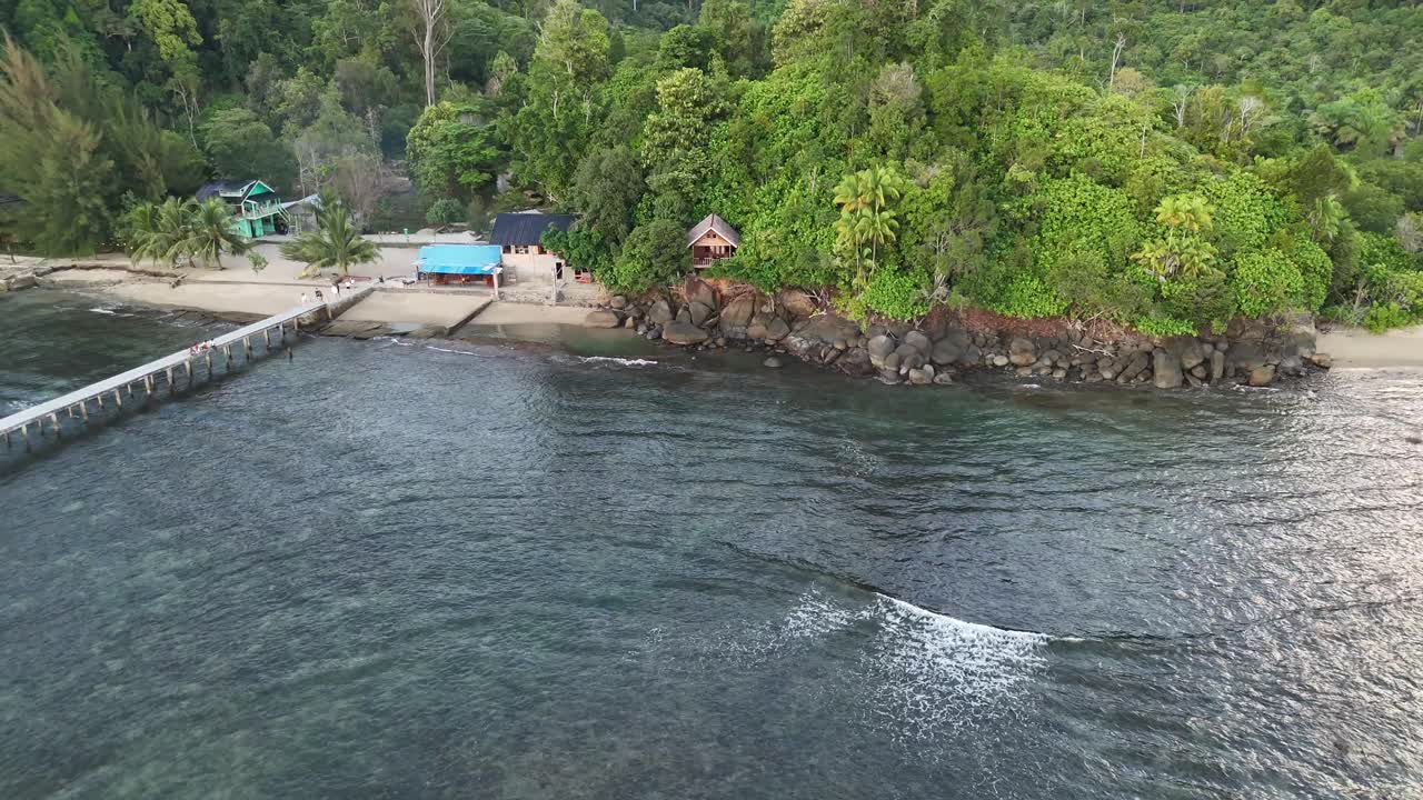 Drone aerial view of indonesian coastline padang west sumatra tropical ocean rainforest jungle trees beach bungalow
