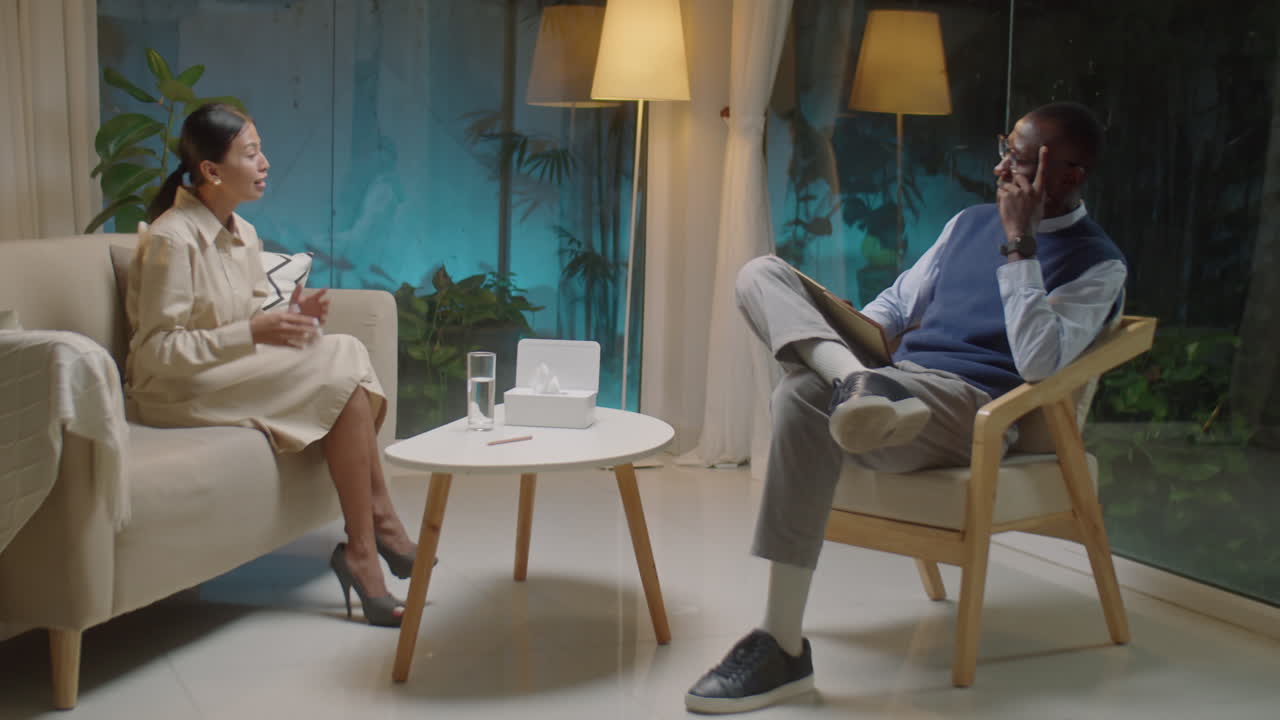 Asian Woman Talking to Psychologist during Therapy Session