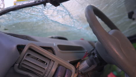 the destroyed dashboard and cracked windshields of a car after an accident