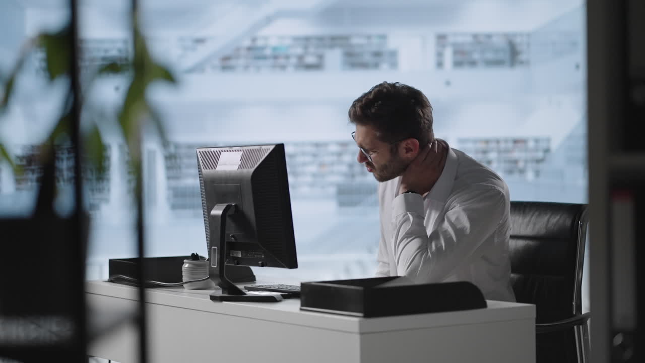 Exhausted man taking off glasses feeling eye strain from computer. Stressed overworked businessman taking off glasses tired from computer.