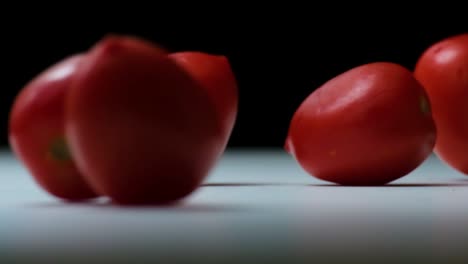 bouncing rolling red and orange ripe tomatoes fresh from the garden basket