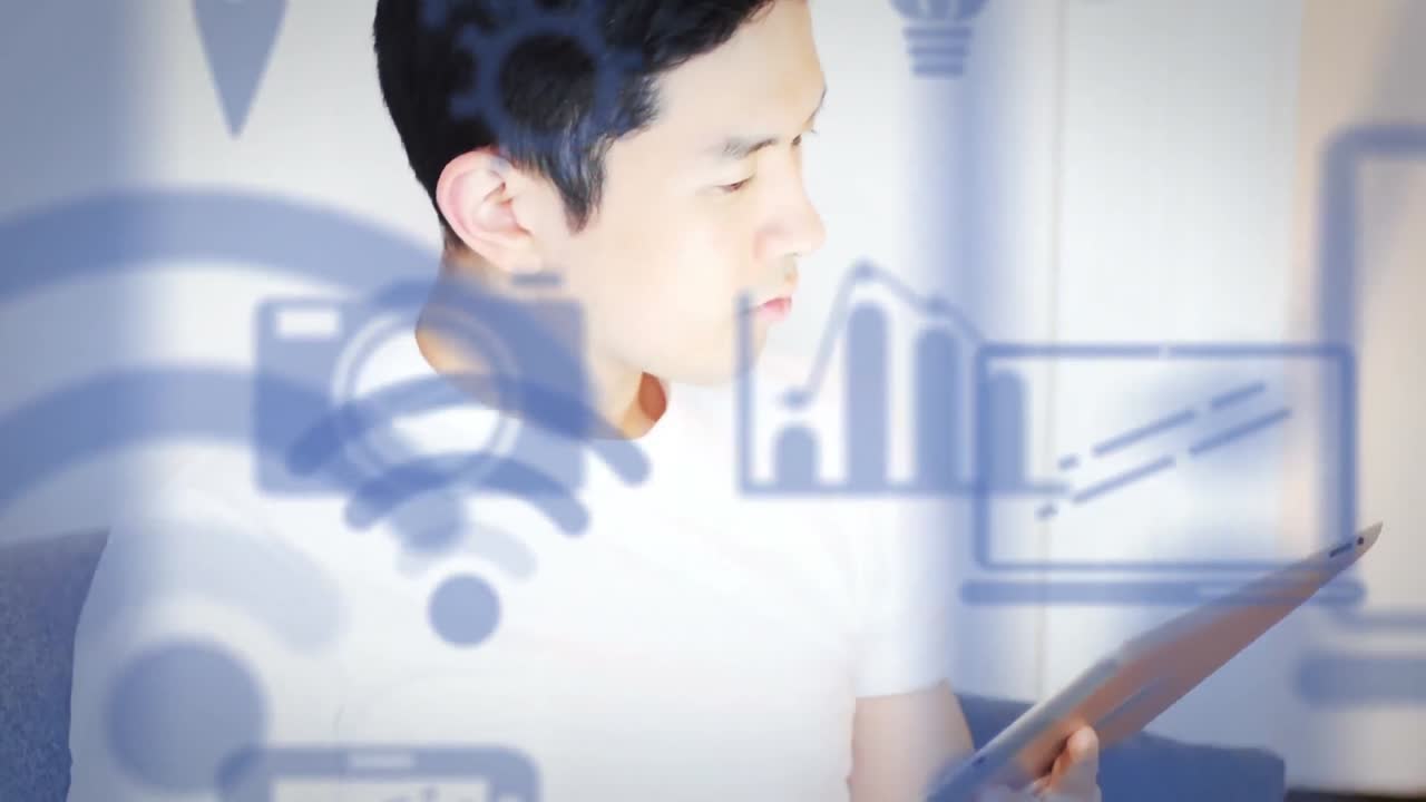 Digital icons moving against man using digital tablet and smartphone