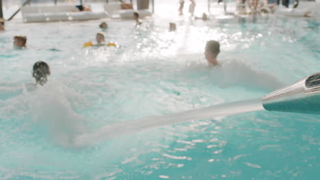 people relaxing in a heated indoor pool