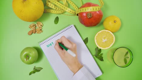 preparing diet program on study table with fruits.