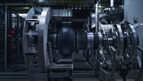 Tyre-production-machine-rotating-in-technological-factory-stamping-product