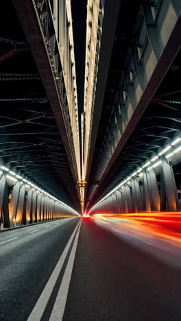 night road under a modern bridge with light trails