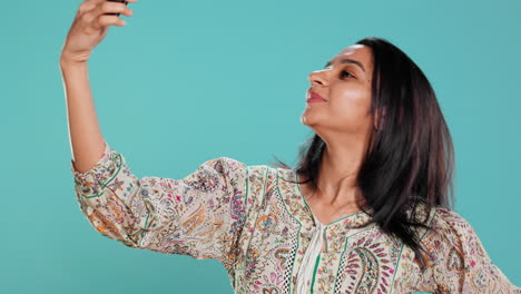 cheerful woman using smartphone to take selfies