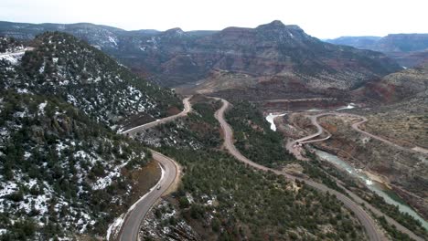 Salt-River-Canyon-Route-60-Arizona,-winding-road-down-to-bridge-over-river--aerial