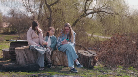 girls using smartphones in park