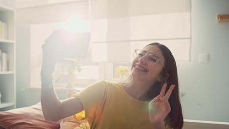 Caucasian-teenage-girl-taking-selfie-with-phone-and-uploading-on-social-media