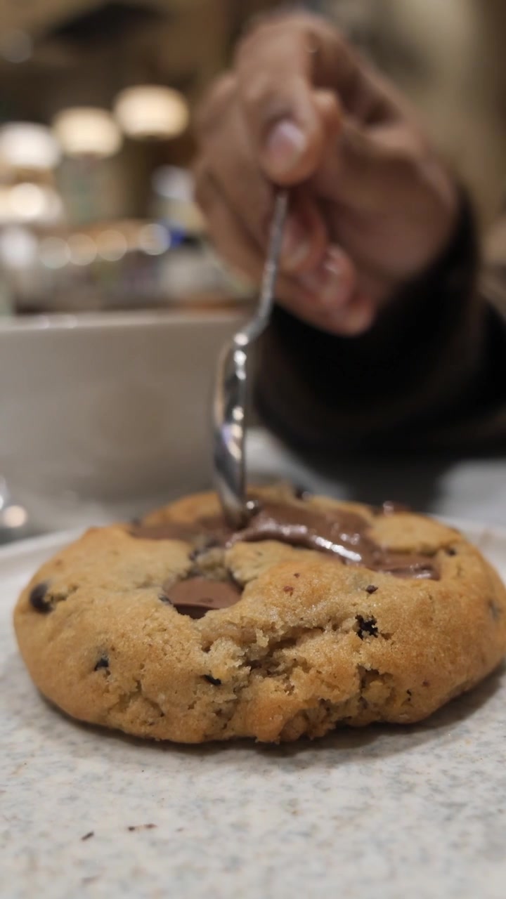 Close-up of Melted Chocolate Being Drizzled on a Cookie