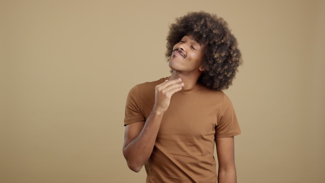A Young Man with Afro Hair Displaying Various Emotions and Poses