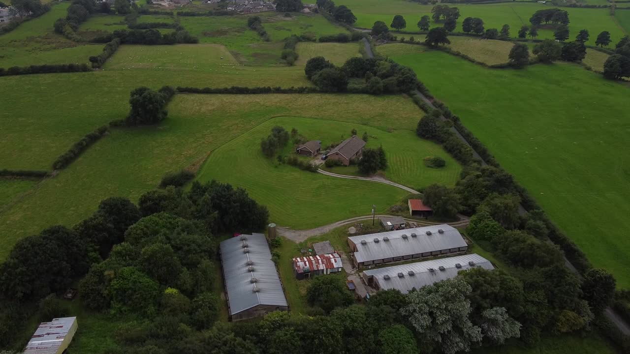 Ripresa aerea di una fattoria britannica nella verde campagna.