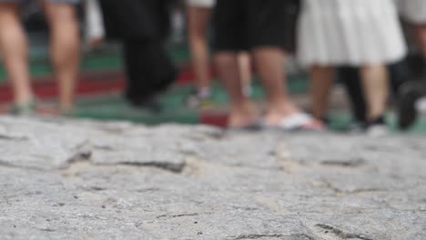 people walking on a stone path