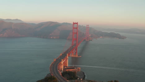 circling aerial shot around the golden gate bridge at dawn