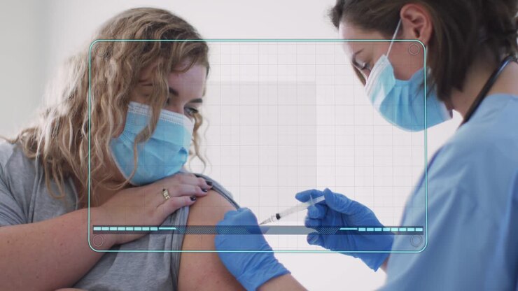 Patient exposing arm while nurse approaching with syringe, giving vaccine, HUD showing chart data